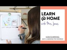 a woman writing on a clipboard with the words learn @ home and mrs jones