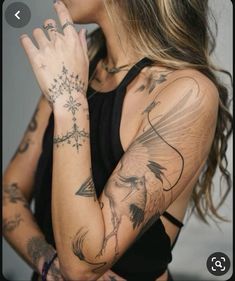 a woman with tattoos holding her hands together