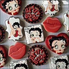 some cookies that have been decorated to look like betty boos and lipstick on them