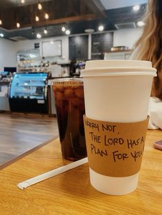 a cup of coffee sitting on top of a wooden table