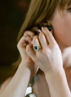 a close up of a person with a ring on her finger