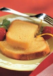 two slices of bread on a plate with strawberries next to it and a fork