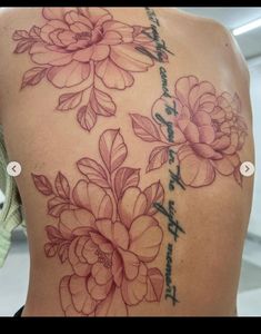 a woman's back with flowers on it and the words, love is in the air