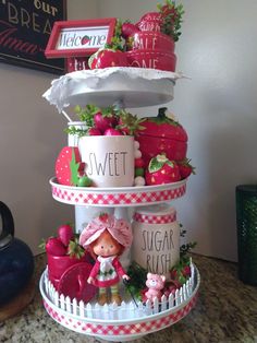 three tiered cake with strawberries and strawberrys on the top, next to a sign that says sweet sugar bake