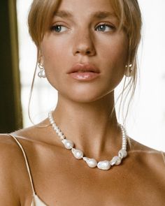 Perfection is boring, we prefer something more unique - just like you & this pearly little number. The Champagne Necklace combines smaller Keshi pearls with the organic forms of bold baroque pearls, to create an elegant yet modern piece of art.

Take centre stage & wear the Champagne Necklace as a standalone statement or pair with our teardrop-shaped Pamplona Earrings for a look as bold as your beautiful heart. 
Details

Handcrafted in a thick layer of 18k gold on sterling silverChain length: 42 Classic Polished Pearl Necklace For Wedding, Formal Polished Pearl Necklace, Wedding Akoya Pearl Beaded Necklaces With Pearl Charm, Elegant Pearl White Necklace With Polished Beads, Classic Wedding Pearl Necklace With Polished Beads, Wedding Akoya Pearl Beaded Necklace With Pearl Charm, Akoya Pearl Charm Beaded Necklaces For Wedding, Akoya Pearl Beaded Necklaces With Pearl Charm For Wedding, Elegant Akoya Pearl Beaded Necklaces For Wedding