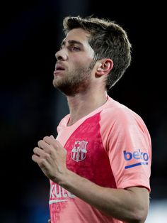 a man with his hands folded and looking up to the sky while wearing a pink shirt