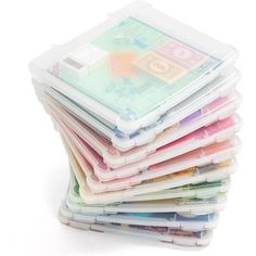 a stack of plastic containers filled with lots of different types of colored papers on top of each other