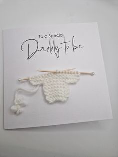 a greeting card with a knitted baby's head on it and the words, to a special daddy to be