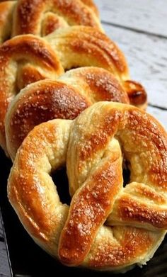 several braided breads sitting on a black plate