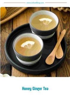 honey ginger tea recipe on a black plate with spoons and cinnamon sticks next to it