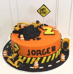 a birthday cake with construction themed decorations on it