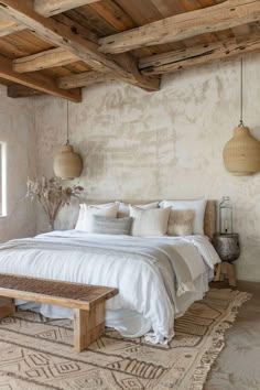 a large bed sitting in a bedroom next to a wooden bench and window on top of a rug