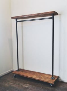 a wooden shelf sitting on top of a hard wood floor next to a white wall