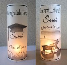 two candles with graduation decorations on them and one is lit up in the shape of a candle