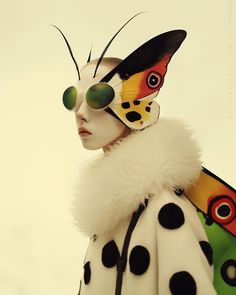 a woman in a butterfly costume with polka dots on her face and black spots on her wings