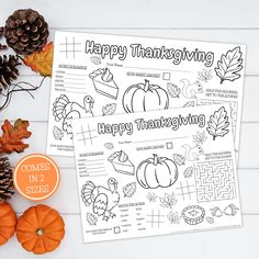 a thanksgiving coloring page with pumpkins, leaves and pine cones on the table next to it