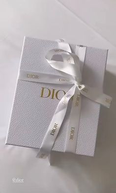 a white box with a ribbon tied around it