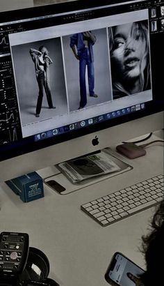 a person sitting at a desk in front of a computer monitor with pictures on it