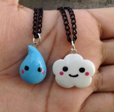 two necklaces that have been made to look like clouds and rain drops on them