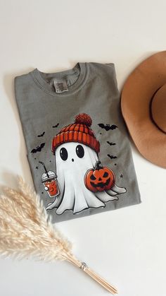 Comfort Colors® Halloween Ghost Shirt, Cute Halloween Shirt, Halloween Women's Shirt, Spooky Season Shirt, Trick or Treat Shirt, Pumpkin Comfort Colors Grey Tshirt  Shirts run true to unisex sizing. Comfortable for both men and women.Please order your regular size for a regular fit, or size down for a more fitted look. Please note unisex shirts are longer than women's shirts. Details: - 100% Cotton - Machine Wash - Soft washed garment dyed fabric - Double needle collar - Twill taped neck and sho Cute Halloween Tshirt Ideas, Pre-shrunk Long Sleeve Halloween Shirt, Spooky Long Sleeve Shirt For Halloween, Casual Halloween Shirt With Cartoon Print, Spooky Cartoon Print T-shirt For Fall, Fun Halloween Streetwear Top, Fall Spooky Cartoon Print T-shirt, Halloween Novelty Shirt With Graphic Print, Fun Halloween Shirt With Cartoon Print