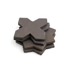 four pieces of black slate are stacked on top of each other in the shape of an x