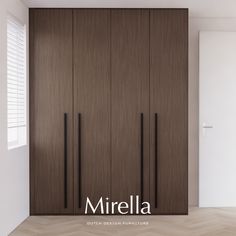 an empty room with wooden closets and white walls in front of the door that reads mirella