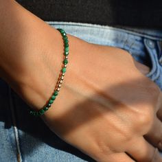 This trendy, very feminine bracelet will enhance most of your outfits, whether casual or dressy. It features authentic malachite of the finest quality, faceted for a dazzling effect. As each stone is unique, bracelets in the same series may vary slightly.   DIMENSION ∙ 16 cm (6,3 inches), 17 cm (6,7 inches), 18 cm (7,1 inches) or 19 cm (7,5 inches), clasp included   COMPOSITION ∙ Malachite ∅ 3 mm (AAA grade, South Africa)  ∙ 14K gold filled round beads ∅ 3 mm ∙ 14K gold filled clasp with spring ring ∙ Strong, durable and flexible high-quality stainless steel cable wire   Please feel free to browse our FAQ section below. You will find all the information you need for an optimal experience before, during and after your purchase. Feminine Bracelet, Elegant Pouch, Malachite Bracelet, Jewellery Box Making, Stainless Steel Cable, Cable Wire, Gift For Her Birthday, Protection Stones, Unique Bracelets