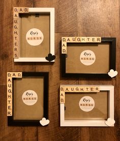 three frames with scrabbles and words on them sitting on a wooden floor