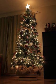 a christmas tree with lights and presents on it