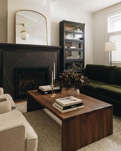 a living room filled with furniture and a fire place in front of a book shelf