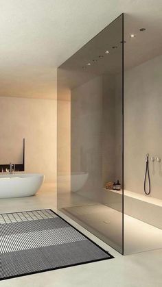 a bath room with a tub a sink and a rug on the floor in front of it