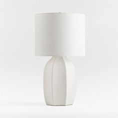 a white table lamp with a white shade