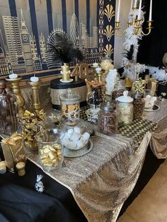 the table is covered with gold and black decorations, such as candles, ornaments, and other items