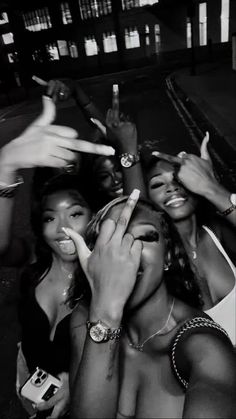 three women posing for the camera with their hands in the air