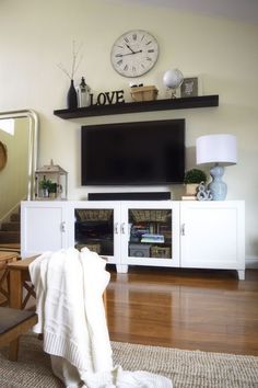 a living room filled with furniture and a flat screen tv