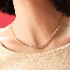 Turn heads with this glamorous Bezel Set CZ Graduated Tennis Necklace! Its minimal yet classy aesthetic will wow all who catch a glimpse. So much style, for so little effort! (It's like you're winning the fashion game with a double ace!) Gold-Plated Brass, CZ Necklace length: 16-18 inches SKU: TN-4194 (G) Minimalist Tennis Necklace For Anniversary, Rhinestone Necklace For Anniversary, Glamorous Diamond Necklace For Anniversaries, Formal Sparkling Necklace, Gold Necklace With Sparkling Details, Classic Diamond Necklace With Sparkling Stones For Party, Classic Diamond Clavicle Chain Necklace For Party, Classic Diamond Clavicle Necklace For Parties, Classic Party Diamond Necklace With Clavicle Chain