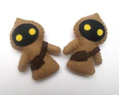 two felt toy figures made to look like they are holding each other's hands