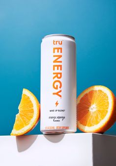 a can of energy drink sitting on top of an orange