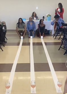 people sitting in chairs with wine glasses on the floor