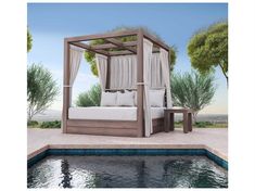 a canopy bed sitting next to a swimming pool