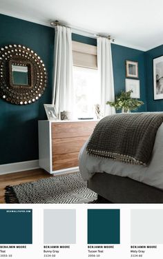 a bedroom with teal walls and white furniture in the room, along with pictures on the wall