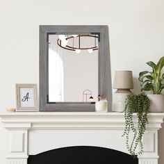 a mirror sitting on top of a mantle next to a fire place