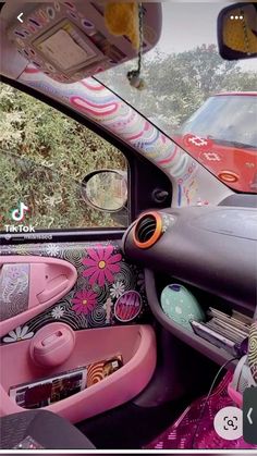 the interior of a car decorated in pink and black with flowers on the dash board