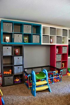 there are many toys in this playroom with colorful shelves and bins on the wall