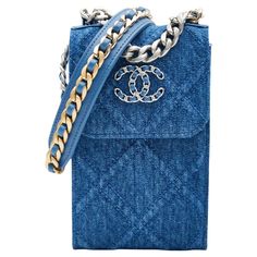 This crossbody bag is made of blue denim with blue leather details and features a sliver chain crossbody strap interlaced with blue leather, a leather shoulder pad, a front flap with snap closure, sliver tone and gold hardware and a blue fabric interior with card slots. Chanel bags with the serial number 31XXXXXX are manufactured from 2021. COLOR: Blue MATERIAL: Cotton - Denim ITEM CODE: 31926315 MEASURES: H 7” x L 4” x D 2” DROP: 26” EST. RETAIL: COMES WITH: Dust bag, care cards, authentication Chanel Phone Holder, Denim Crossbody Bag, Chanel Blue, Chanel 19, Blue Jeans Crafts, Planner Covers, Denim Crossbody, Denim Handbags, Denim Quilt