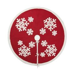 a red and white round rug with snowflakes on the top, hanging from a hook