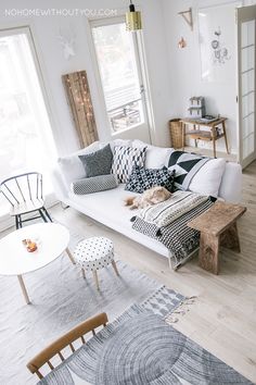 a white couch sitting in a living room on top of a wooden floor