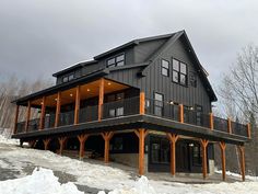 a large house sitting on top of a snow covered slope