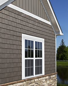 House exterior finished in ProVia Timberbay Cedar Shakes, Board n' Batten vinyl siding and stone veneer Painted Brick And Vinyl Siding House Exterior, Clapboard And Shingle Siding, Bottom Brick Top Siding, Board And Batten Cedar Shake, House With Shingles And Siding, Shake Shingle Siding Color Schemes, Cedar Shingles With Board And Batten, Cedar Shakes And Board And Batten, Board And Batten With Cedar Shakes