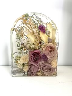 a glass vase with flowers in it on a table